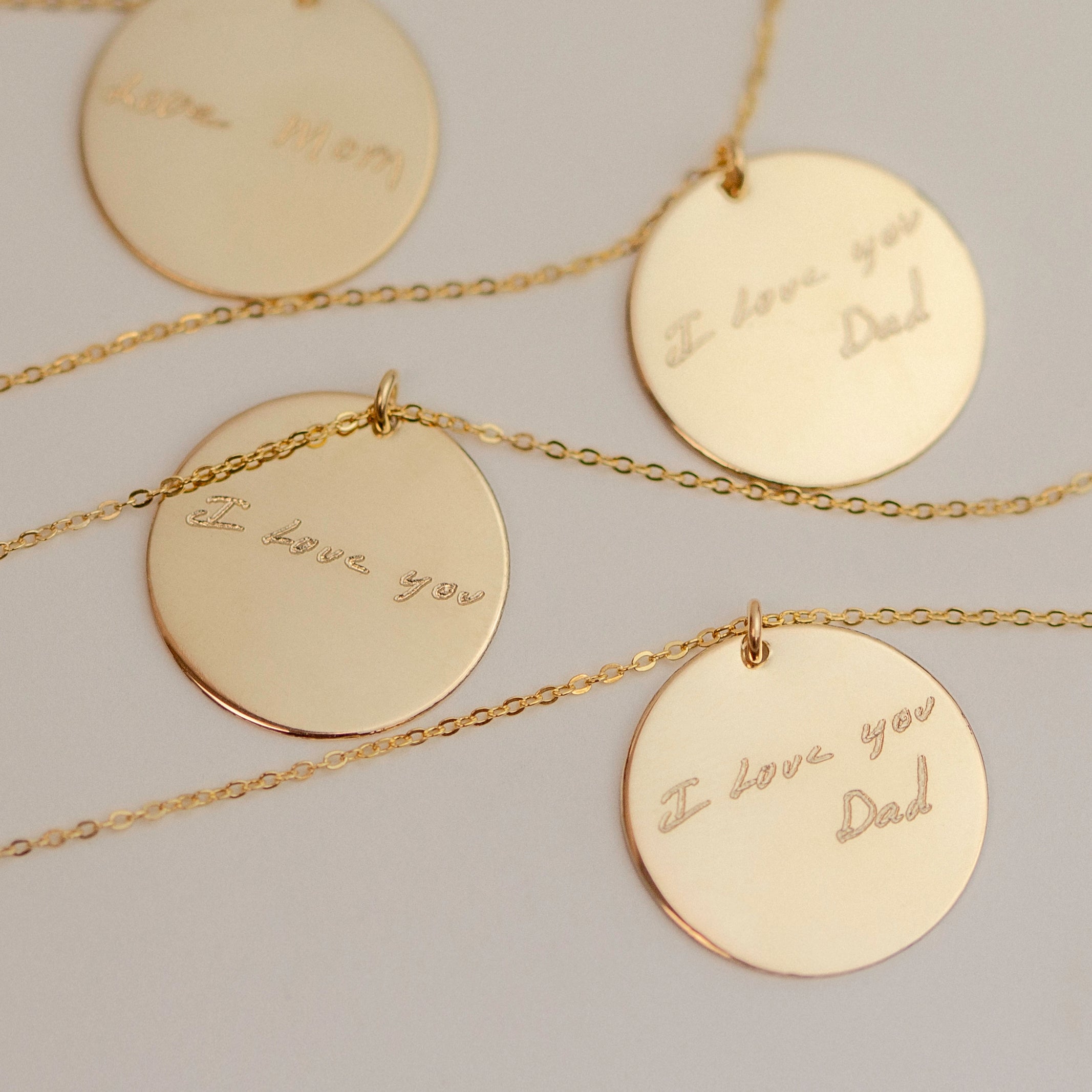 Each pendant has a handwritten message. The messages are 'I love you Dad', 'I love you Dad', 'I love you', and 'Love Mom'.