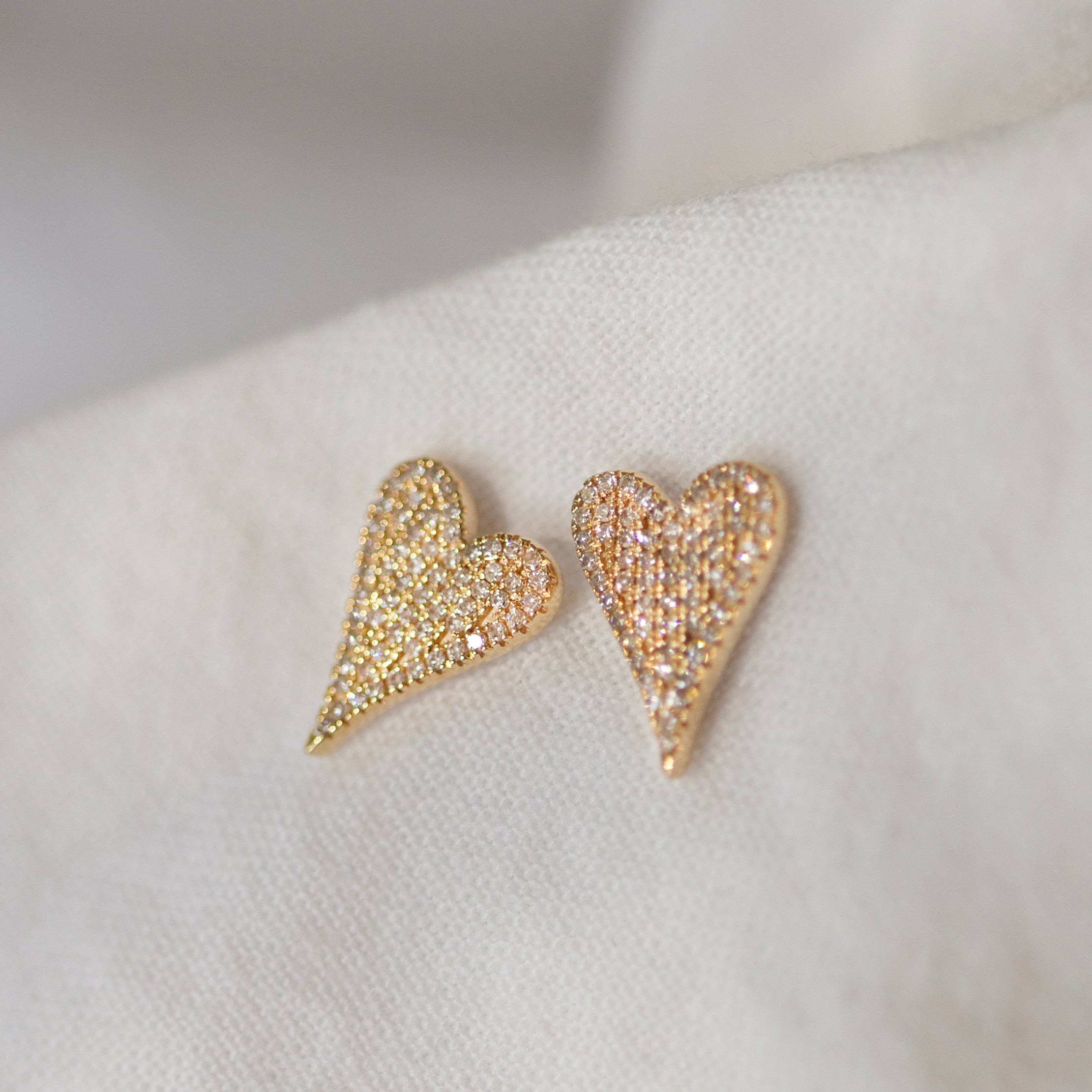 Small Pave Diamond Heart Earrings
Elevate your style with these elegant 14K Small Pave Diamond Heart Earrings. Exquisitely crafted with small pave diamonds for a subtle yet, luxurious look. These earrings make a perfect gift or an exquisite addition to your own collection. Be sure to sparkle and shine with these exquisite heart-shaped delights.