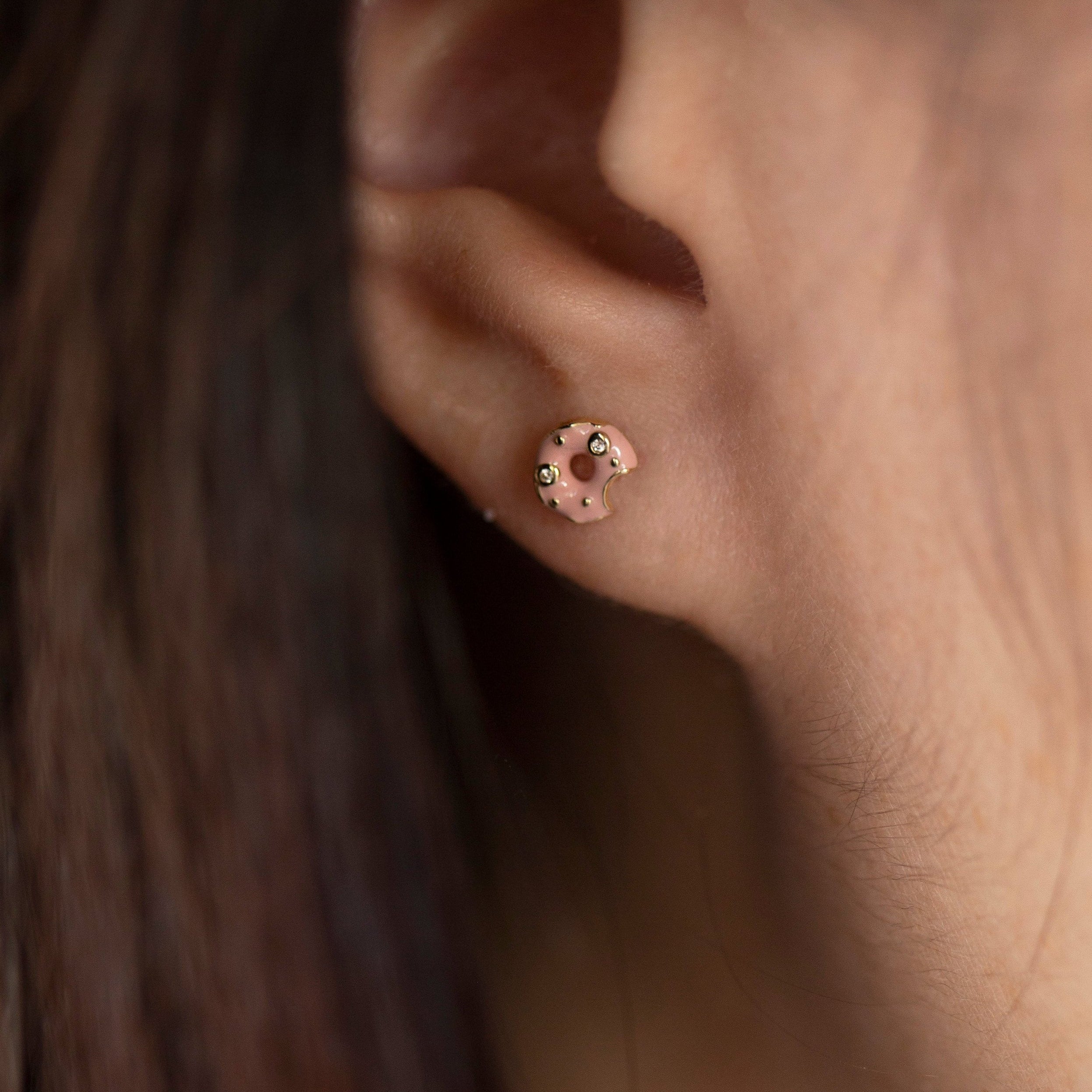 Elevate your style with these 14k diamond and enamel donut post earrings, crafted with brilliant diamond sprinkles and pink enamel frosting. 