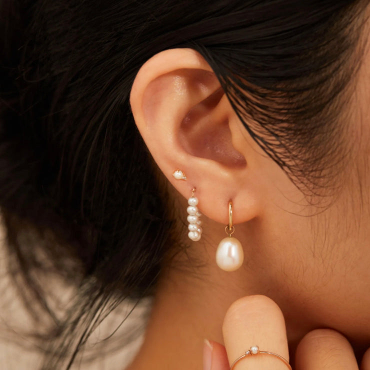 These 14k gold Freshwater Pearl Strand Earrings are a timeless and elegant accessory. Crafted from 14k yellow gold and freshwater pearls, they make an ideal bridal jewelry or bridesmaid gift. Their classic style make them a must-have in any woman's jewelry collection.