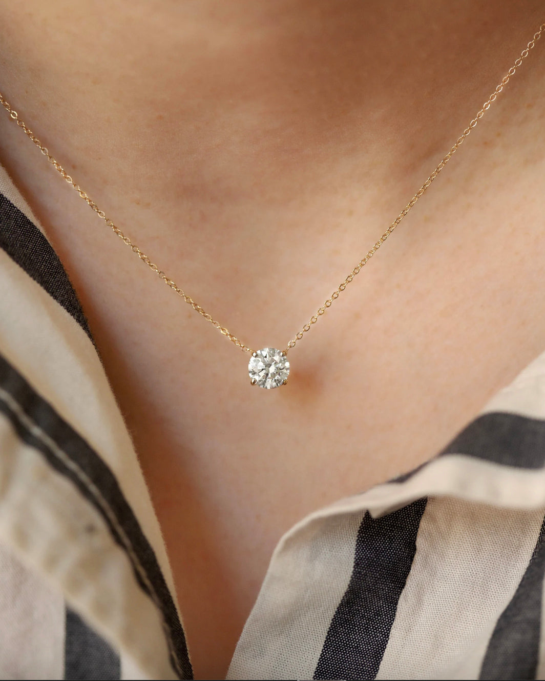 Elevate your look with the classic Diamond Necklace. Featuring a graceful floating lab-grown diamond set in a 4-prong setting for maximum sparkle and brilliance, this exquisite 14k white gold pendant is a classic piece that will bring allure to any ensemble.