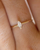 Gold ring with a diamond on a finger