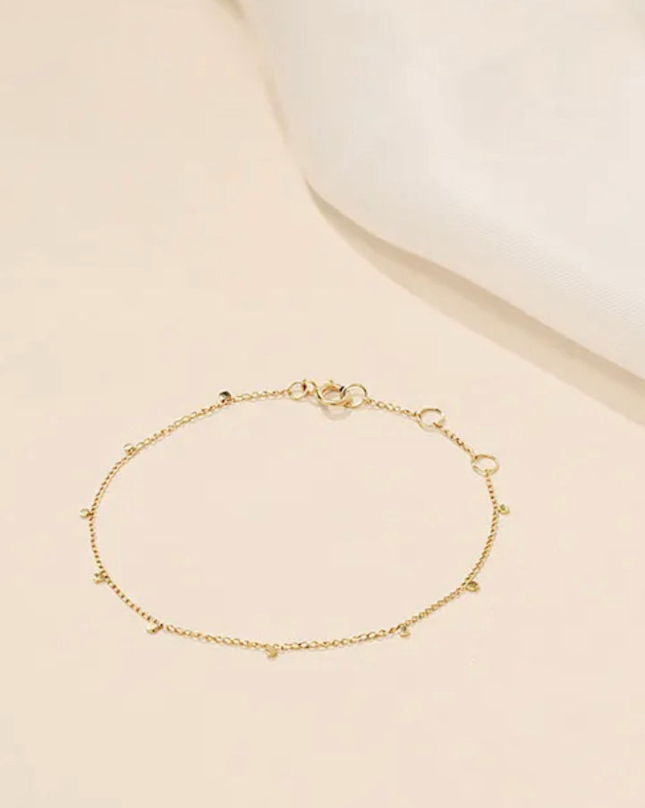 The chain is crafted with 14K yellow gold discs attached to a delicate 14K gold curb chain, creating a seamless row. Its bohemian and luxurious design allows for versatile styling, whether wearing alone or mixing with other favorites.