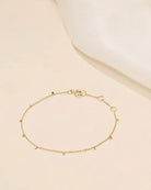 The chain is crafted with 14K yellow gold discs attached to a delicate 14K gold curb chain, creating a seamless row. Its bohemian and luxurious design allows for versatile styling, whether wearing alone or mixing with other favorites.