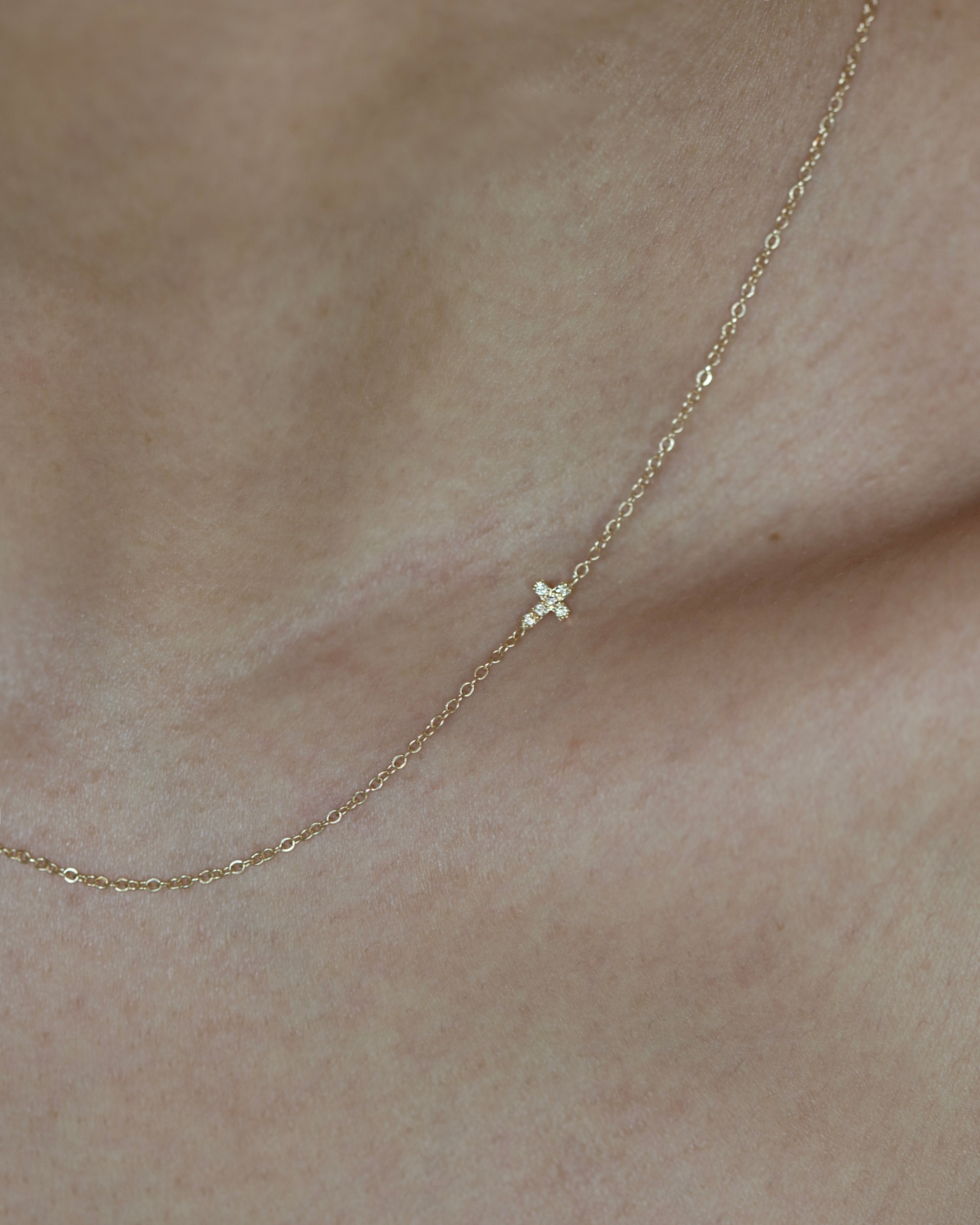 Asymmetrical Diamond cross necklace - This simple cross necklace is both understated and significant, perfect for daily wear and layering with other necklaces. Ideal for a confirmation or baptism present, this minimalistic necklace features a delicate chain and a sparkling diamond charm, symbolizing faith.