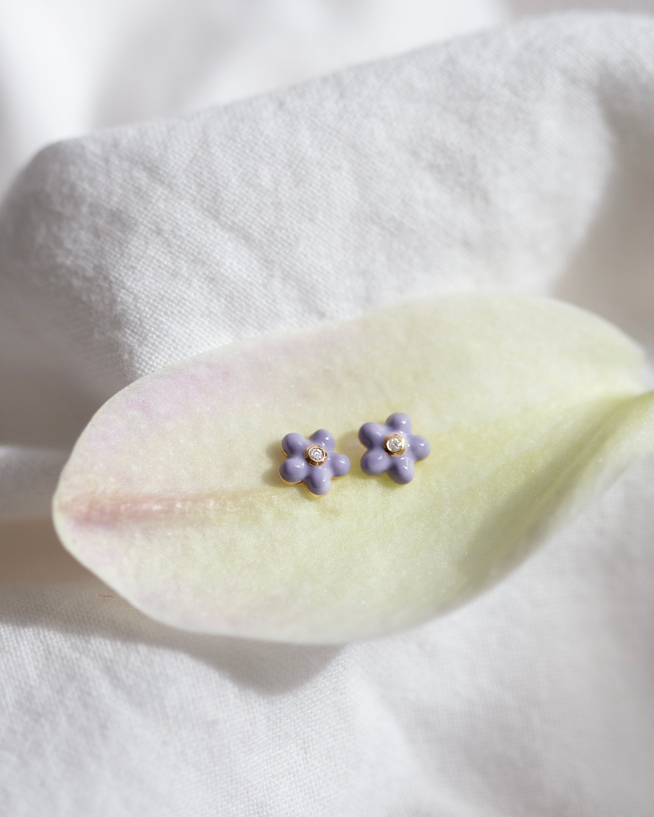 beautiful violet enamel flower and a sparkling diamond accent. 