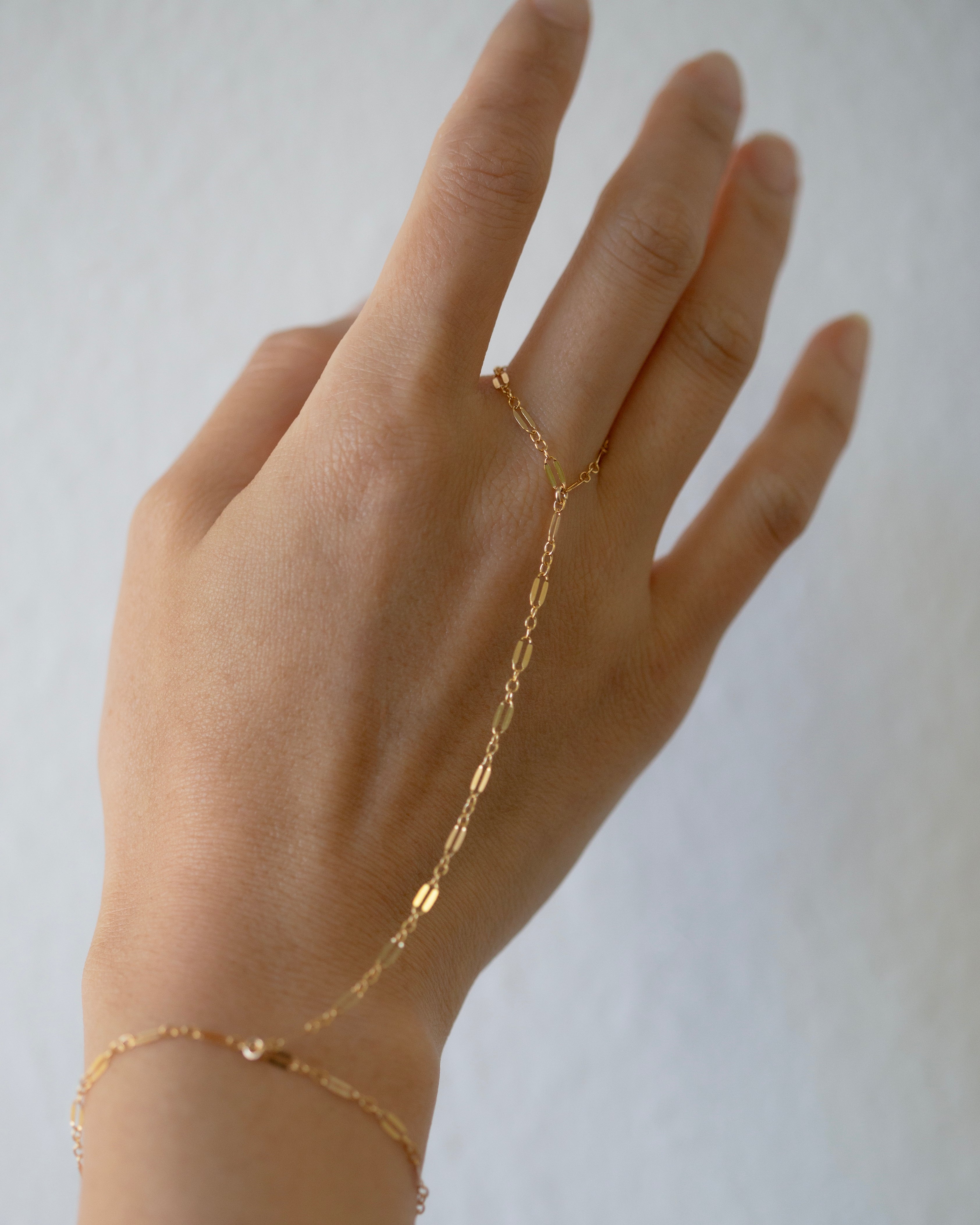 This exquisite and delicate hand chain with&nbsp;lace chain is a stylish, effortlessly elegant way to elevate your look. Perfect for layering and creating a boho aesthetic, this understated bracelet is also available in sterling silver. Make a statement with this tasteful and luxurious accessory for a timelessly sophisticated finish.