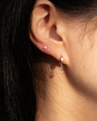 Diamond huggie earrings in yellow gold