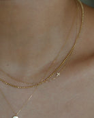 Asymmetrical Diamond cross necklace - This simple cross necklace is both understated and significant, perfect for daily wear and layering with other necklaces. Ideal for a confirmation or baptism present, this minimalistic necklace features a delicate chain and a sparkling diamond charm, symbolizing faith.