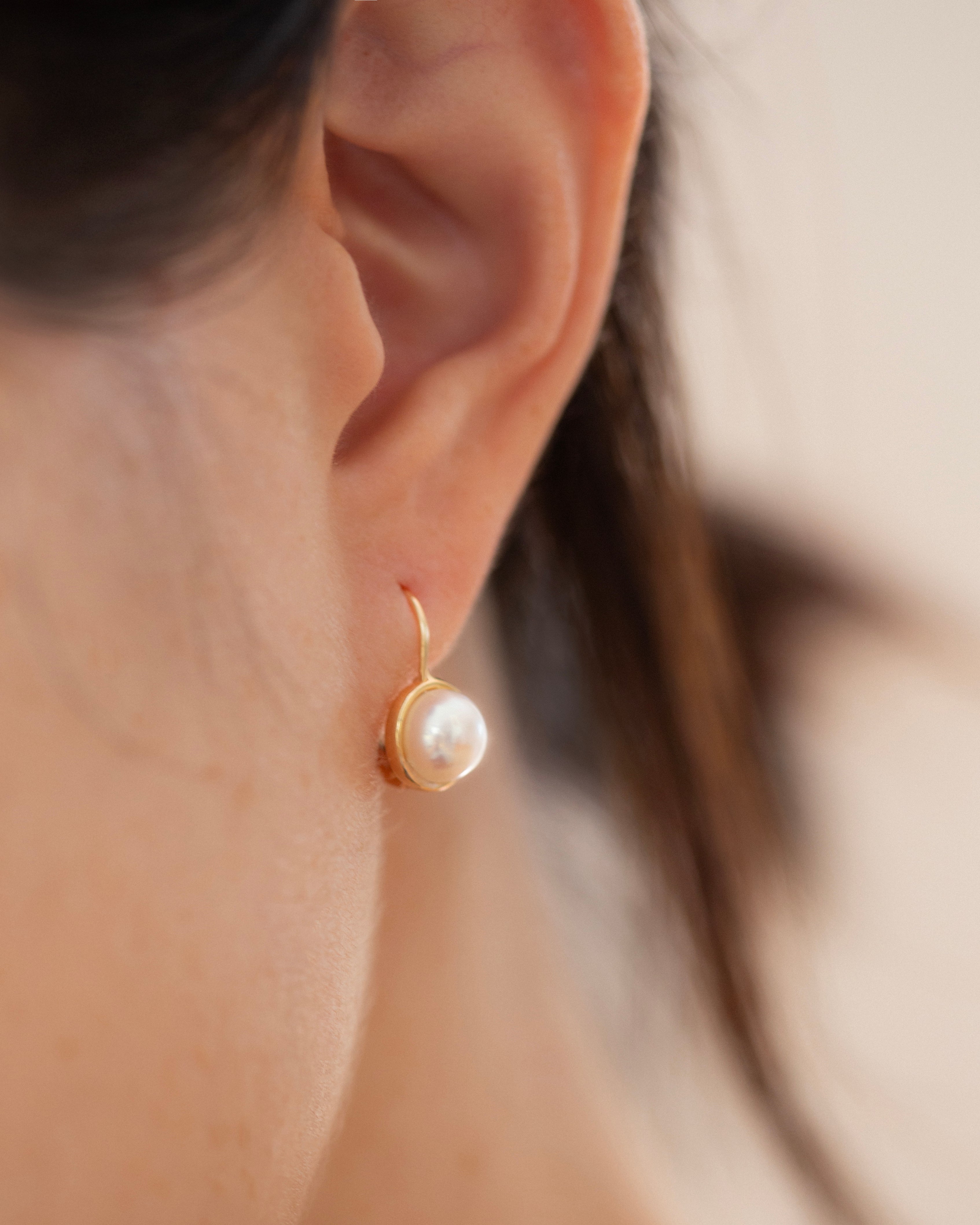 These 14k gold earrings feature a 7mm white cultured pearl and secure lever back closure.