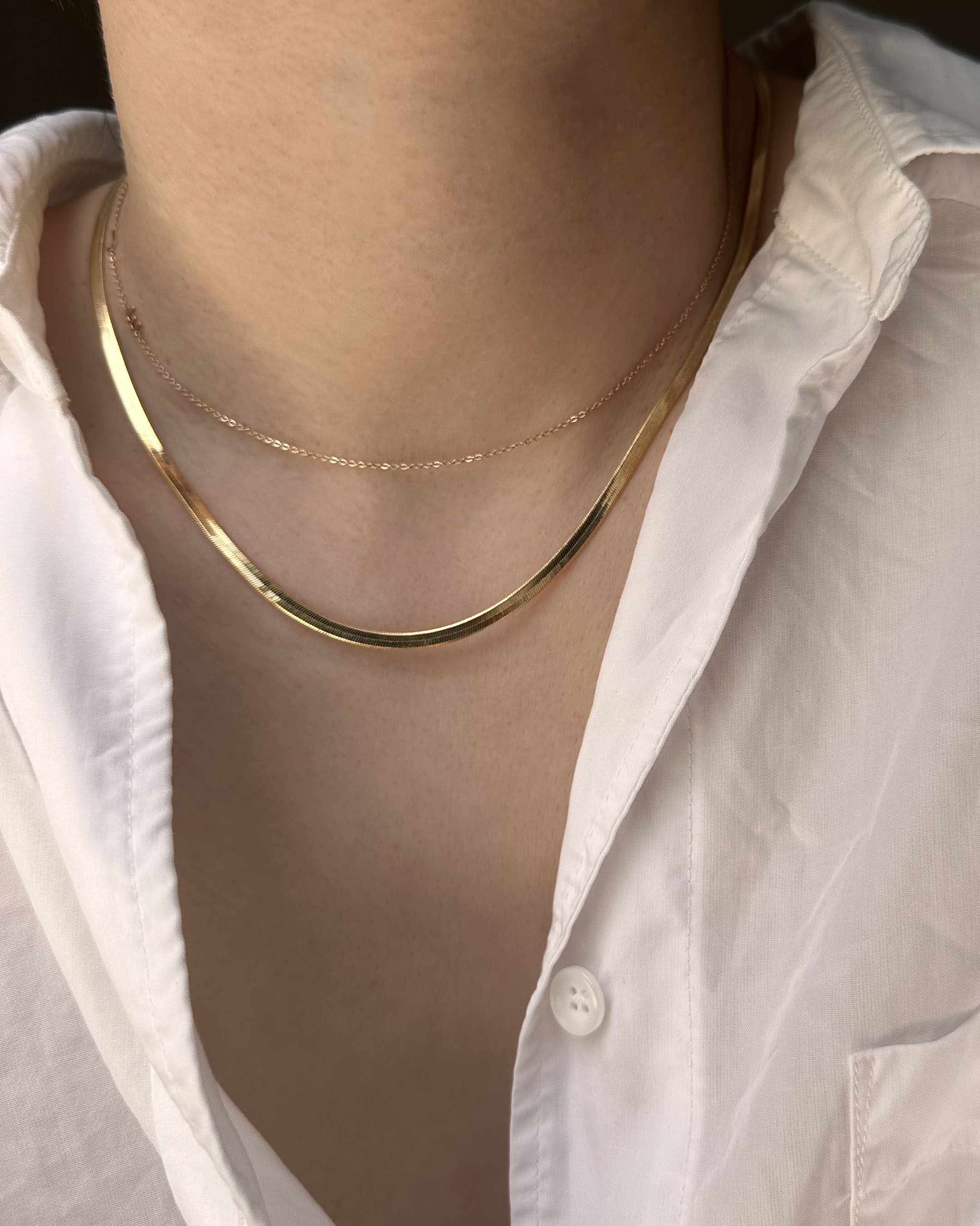 Our 14k Herringbone Snake Chain Necklace is the perfect addition to any wardrobe. Crafted from 14k gold, this necklace is lightweight and long lasting. The intricate herringbone design ensures durability, without sacrificing style. Whether it’s for a special occasion or everyday wear, this necklace is always in style.