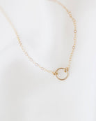 This exquisitely crafted 14K gold halo circle charm necklace exudes a sense of simplicity and elegance, making it the perfect addition to your everyday wardrobe.