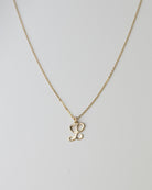 Cursive Letter Charm Necklace. Perfect wearing alone or layering with your favorite necklaces.