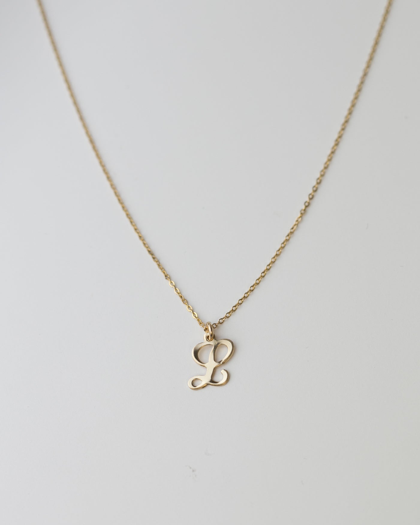 Cursive Letter Charm Necklace. Perfect wearing alone or layering with your favorite necklaces.