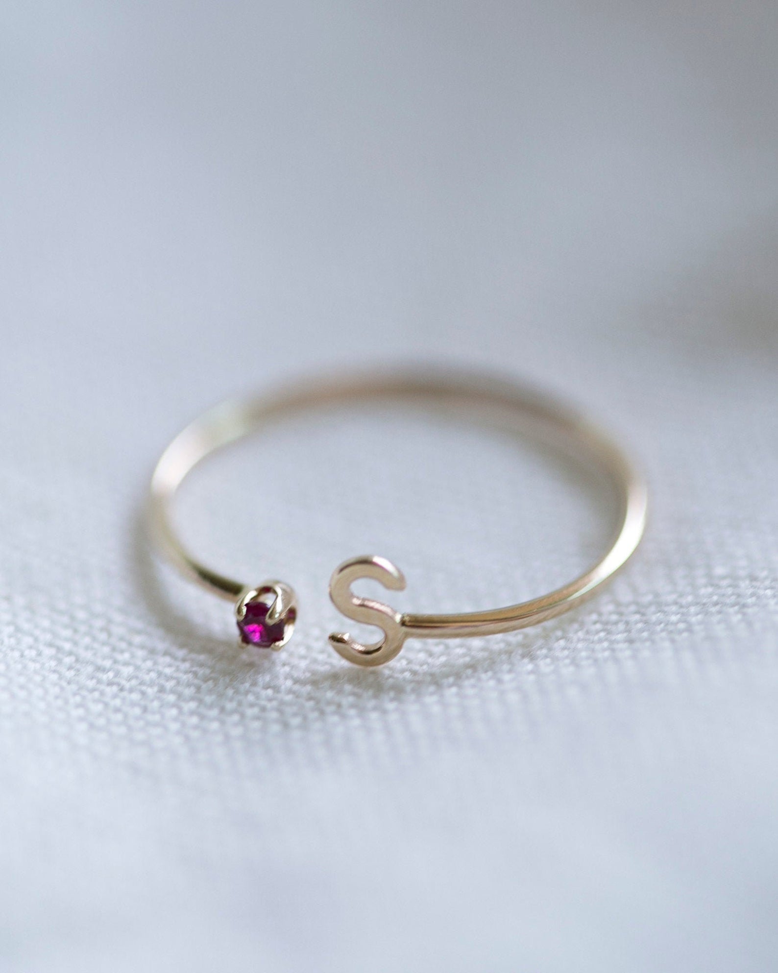 Elevate your style with our exquisite 14k Gold Initial Ring, adorned with a birthstone of your choice. Personalize it with an Uppercase letter A-Z, making it a one-of-a-kind piece. A thoughtful and luxurious gift for yourself or someone special.