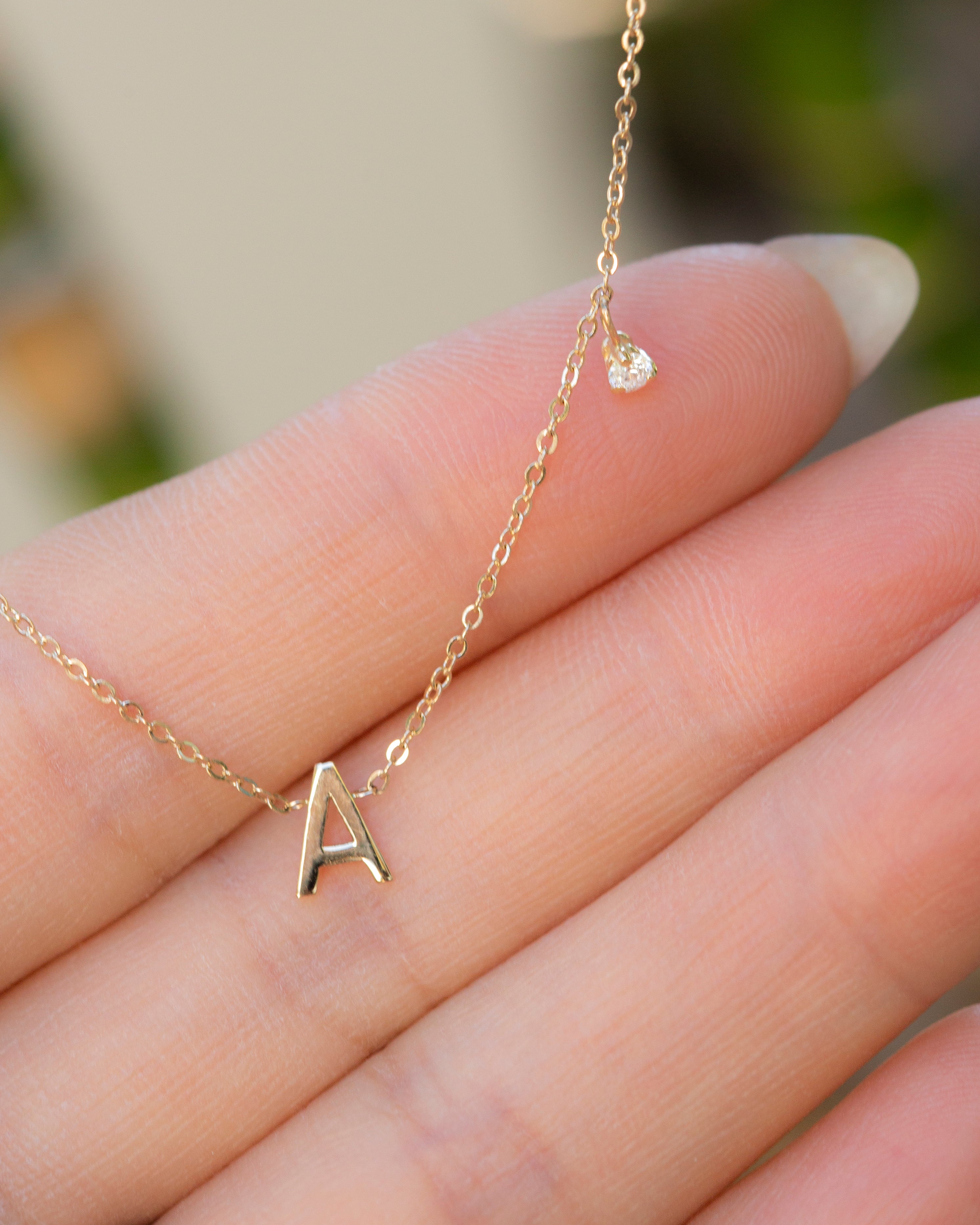  14k gold initial necklace, embellished with a delicate side diamond dangle. 