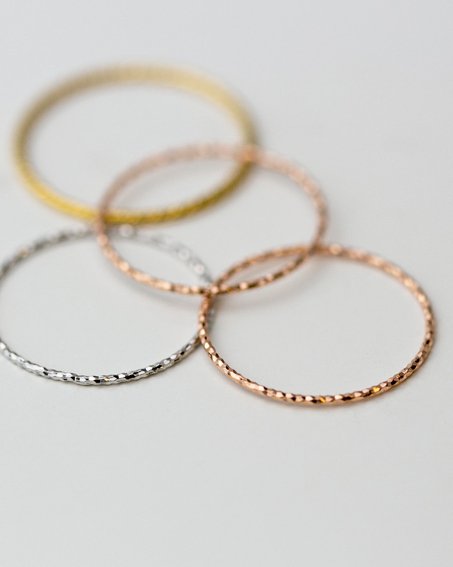 Crafted from 14k gold and featuring a diamond-cut design, these stacking rings offer a dainty and simplistic look that is perfect for everyday wear.