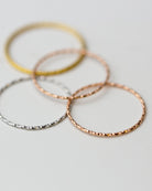 Crafted from 14k gold and featuring a diamond-cut design, these stacking rings offer a dainty and simplistic look that is perfect for everyday wear.