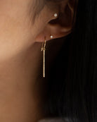 These exquisite 14k gold drop bar earrings feature genuine diamonds, adding a modern touch to their versatile design. A must-have for those seeking a timeless and sophisticated accessory.