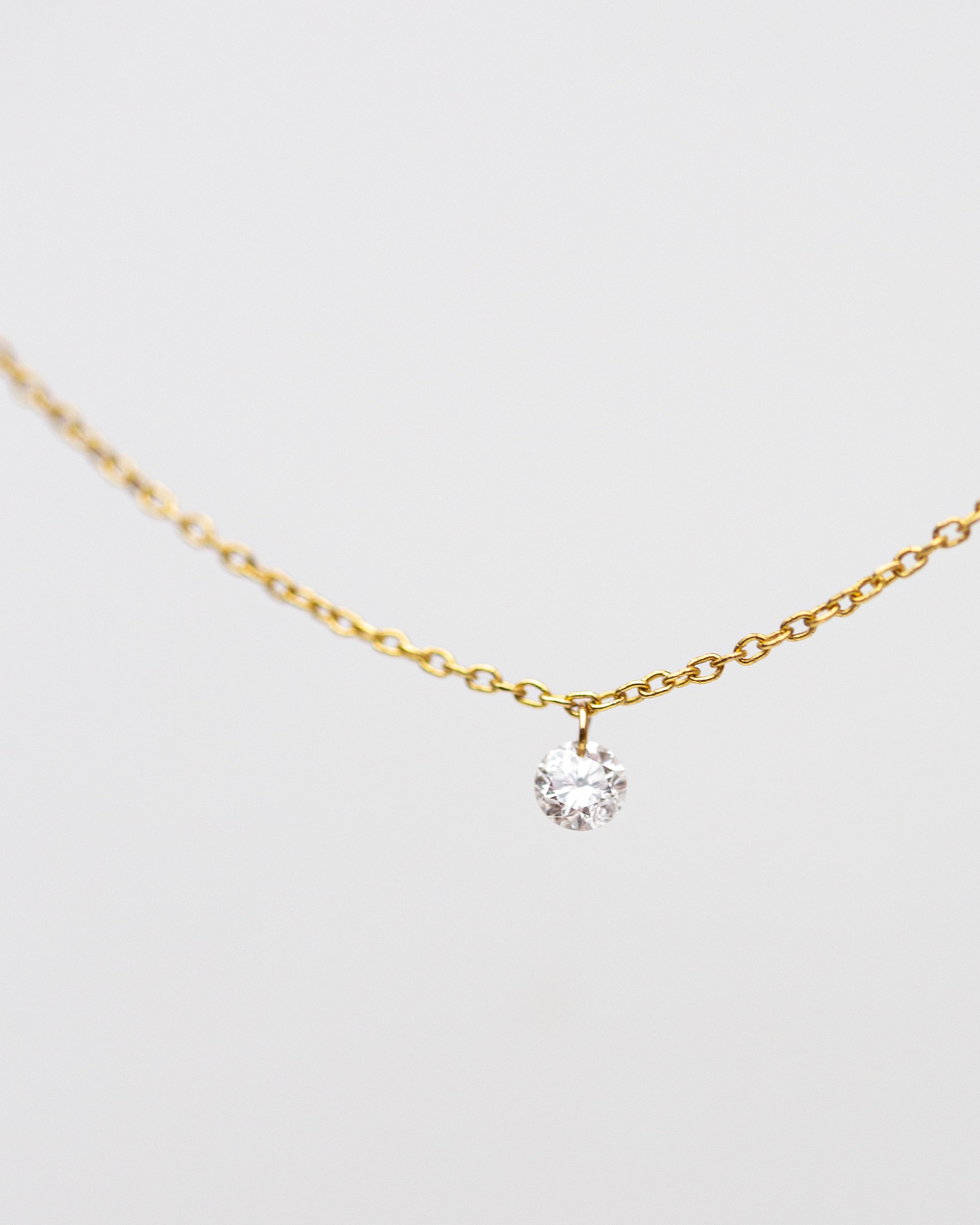 14k Gold chain with beautiful diamond in a drilled jump ring setting
This gorgeous minimalist diamond solitaire necklace features a .1ct round brilliant diamond on a dainty chain as if the diamond was naked.