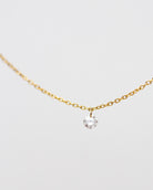 14k Gold chain with beautiful diamond in a drilled jump ring setting
This gorgeous minimalist diamond solitaire necklace features a .1ct round brilliant diamond on a dainty chain as if the diamond was naked.