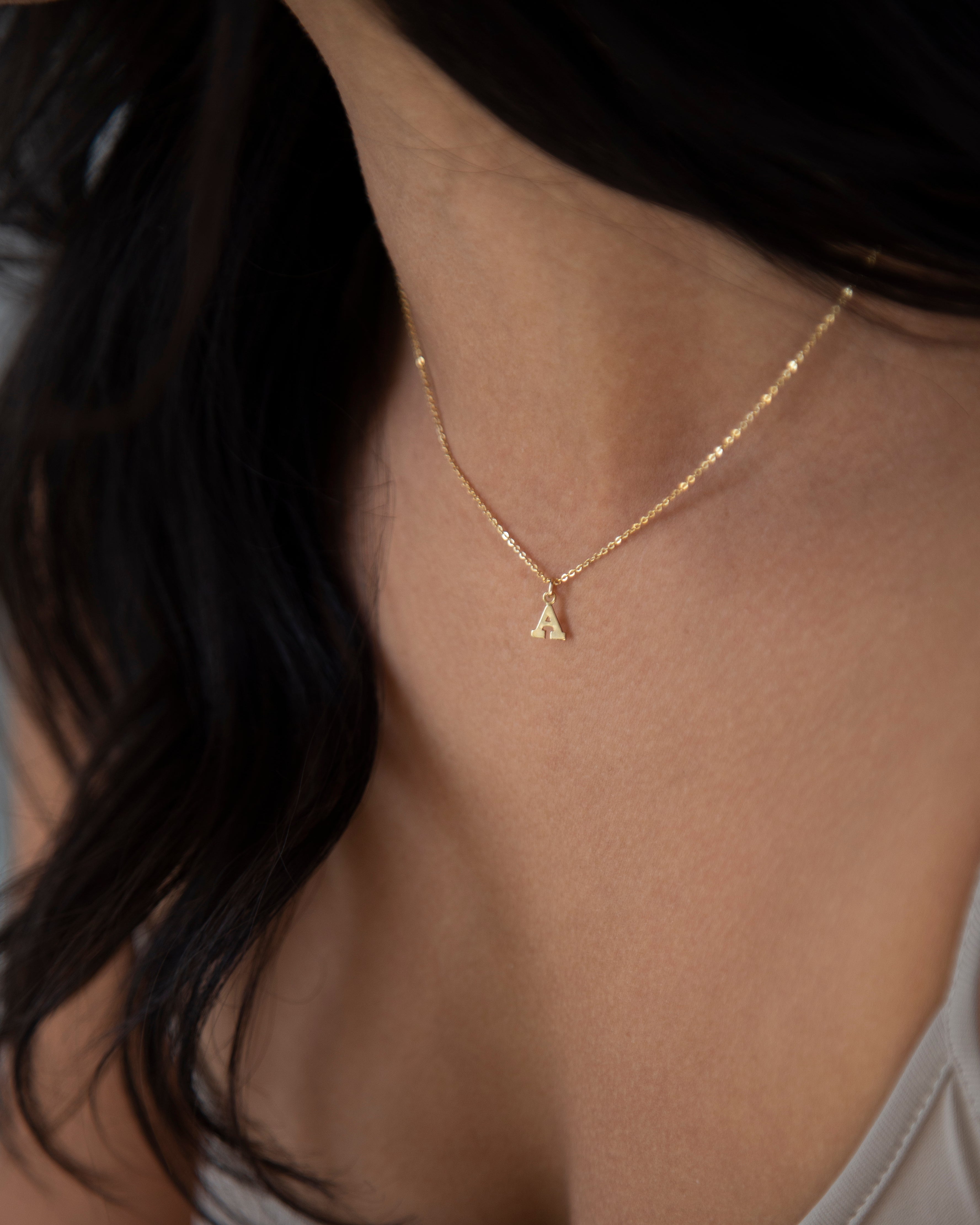 Mini initial necklace, perfect for adding a personal touch to any outfit.
Dainty Initial Necklace - Perfect wearing alone or layering with your favorite necklaces.
