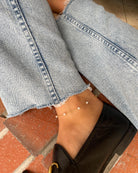 A gold chain anklet with small white pearls