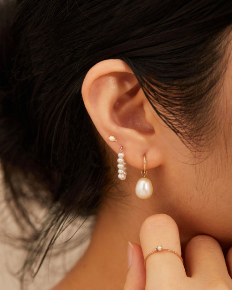 These 14k gold Freshwater Pearl Strand Earrings are a timeless and elegant accessory. Crafted from 14k yellow gold and freshwater pearls, they make an ideal bridal jewelry or bridesmaid gift. Their classic style make them a must-have in any woman's jewelry collection.