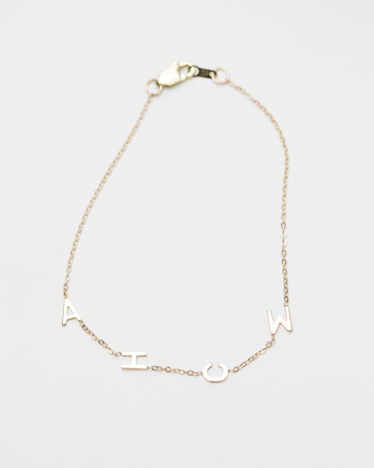 Customize your 14K solid gold initial bracelet. An understated, sleek everyday accessory. Ideal for gifting your loved one.